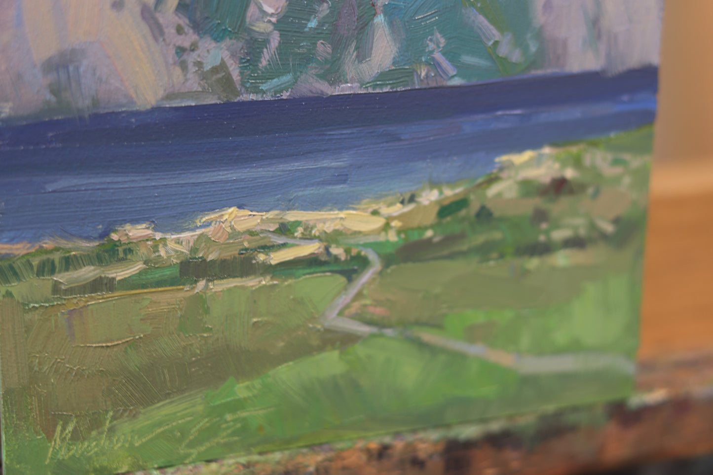 Original oil painting of a serene mountain lake in the Lake District, UK, featuring dramatic cliffs, deep blue water, and lush green fields under a soft evening light.
